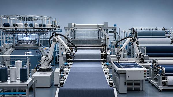 What slows textile industry automation after pilot success?