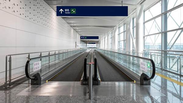 Are Destination-Dispatch Moving Walks Reliable Under Heavy Traffic?