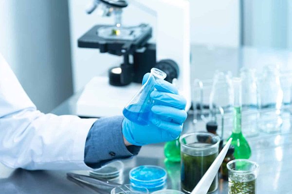 person-holding-laboratory-flask-2280571-scaled-e1590997122373