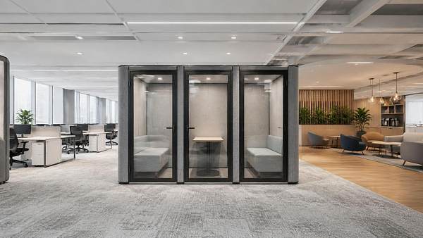 Where should acoustic work pods be placed to reduce office noise?