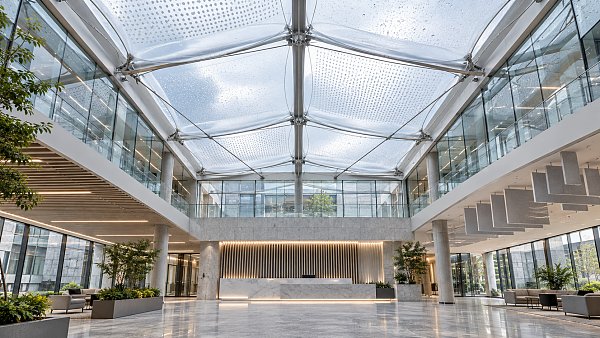 ETFE Roofing for Atriums: Managing Solar Gain, Glare, and Rain Noise
