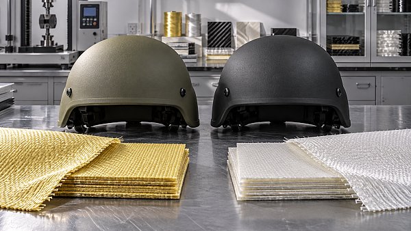 How do aramid and UHMWPE compare as ballistic materials for helmets?