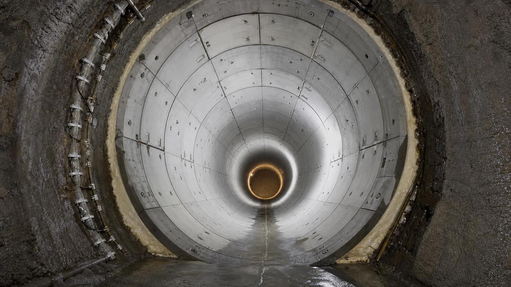 When does a tunnel lining system need segmental lining instead of cast-in-place concrete