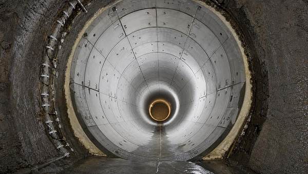 When does a tunnel lining system need segmental lining instead of cast-in-place concrete