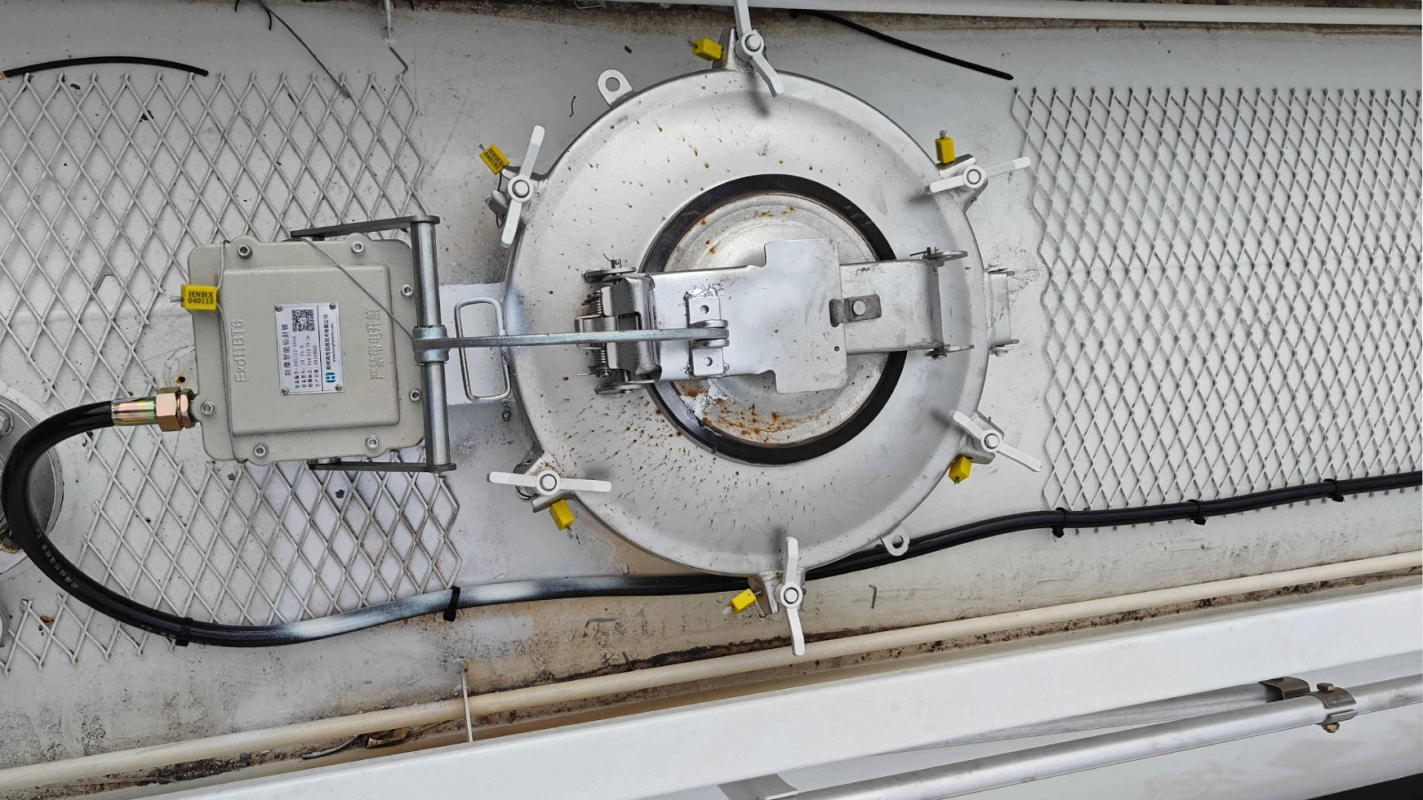 Intelligent manhole cover lock installed on oil unloading ports for enhanced security.