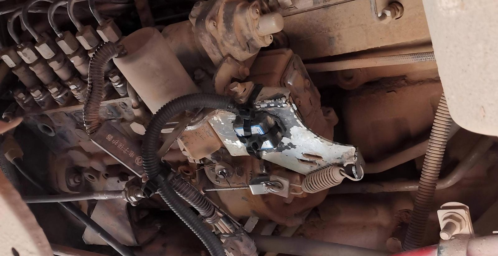 Installation of fuel anti-theft equipment including smart flexible locks and ultrasonic level sensors on heavy-duty construction vehicles.