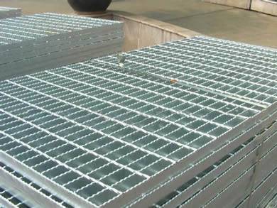 Safety serrated welded steel bar grating panels with galvanized surface treatment on the ground.