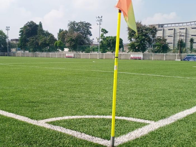How does artificial grass protect players?