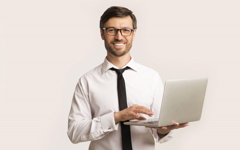 successsful-man-working-on-laptop-standing-UAHSPPD-800x499.jpg