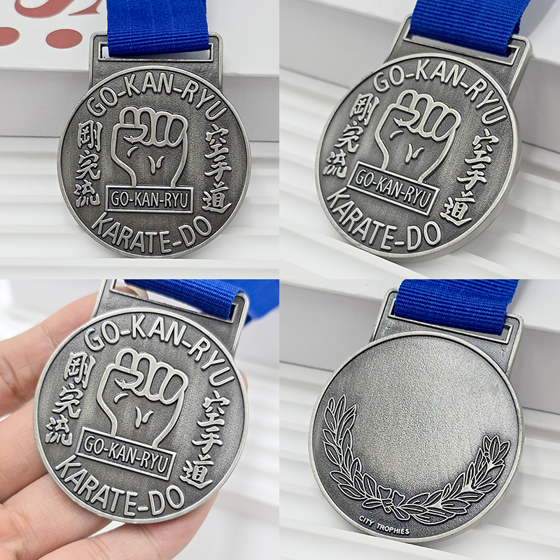 Retro silver metal medal with 3D fist relief, commemorative collectible item for karate-themed events.