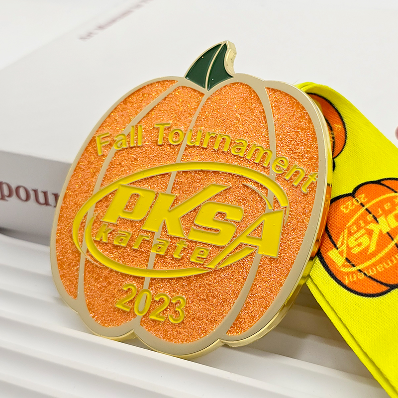 Orange and gold color-blocked pumpkin-shaped metal medal, commemorating the 2023 PKSA Karate Autumn Championships, Halloween-themed collectible item.