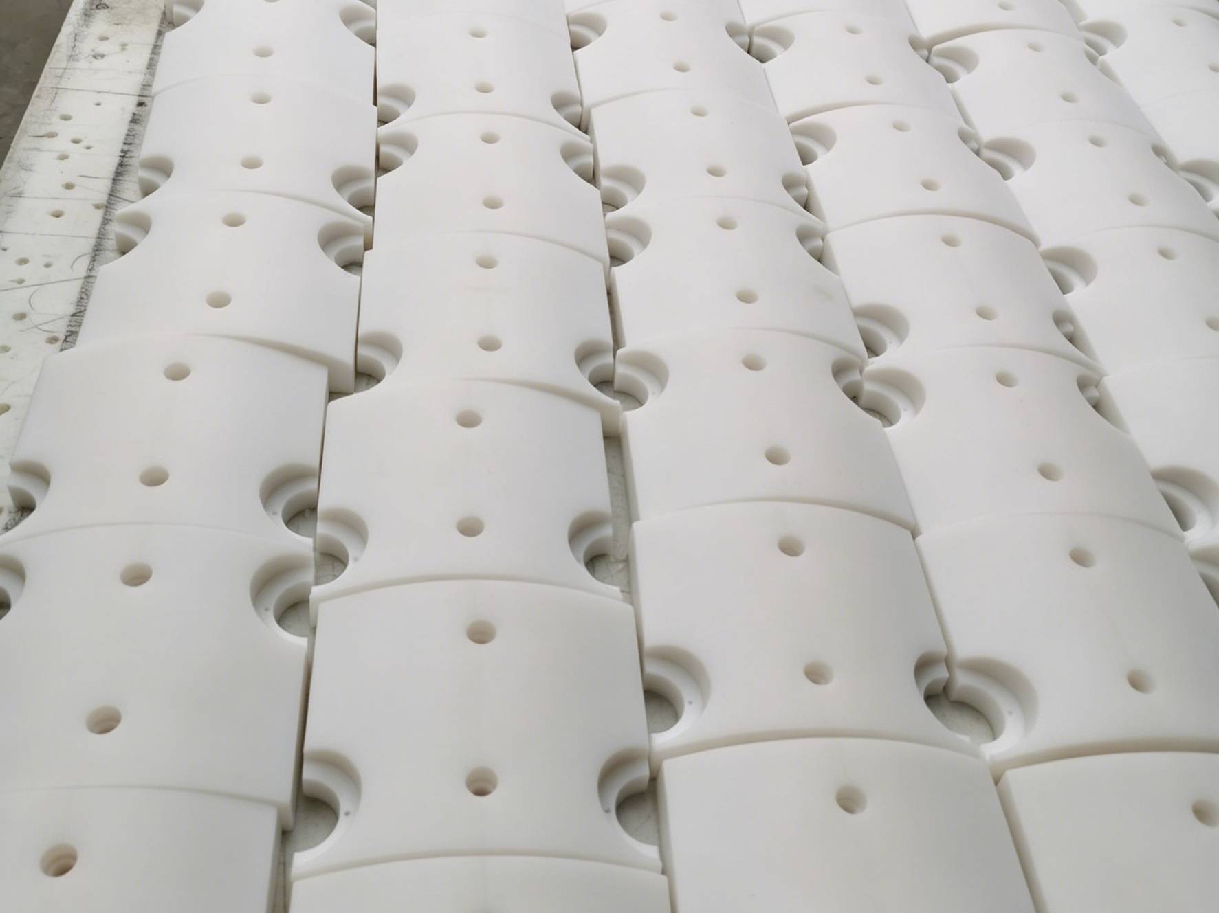 Record of an actual project involving the machining of custom-engineered saddles from UHMW-PE sheet