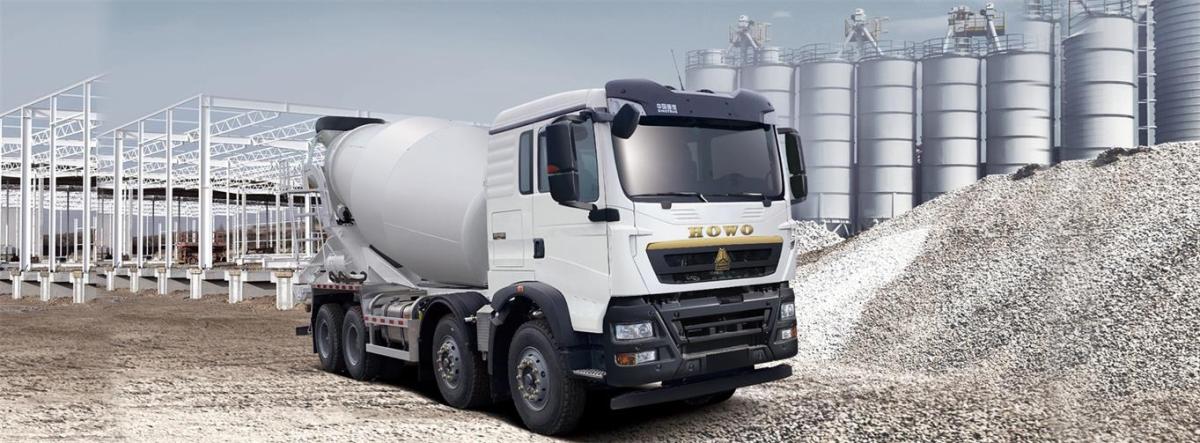 Howo A7 6x4 concrete mixer truck front three quarter view highlighting chassis and mixer drum Howo A7 6x4 concrete mixer truck front three quarter view highlighting chassis and mixer drum