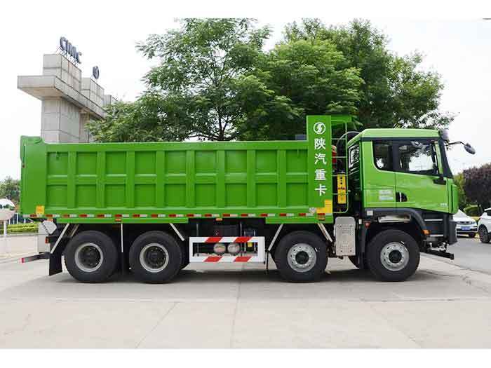 Shacman X5000 8x4 heavy duty dump truck side view showing multi axle configuration and large capacity cargo box