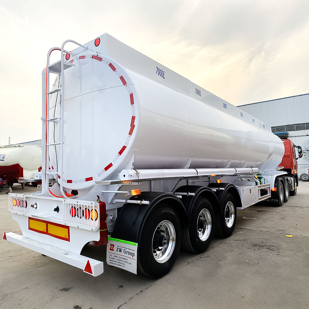 Carbon steel fuel tanker semi trailer rear three quarter view showing discharge system and rear platform