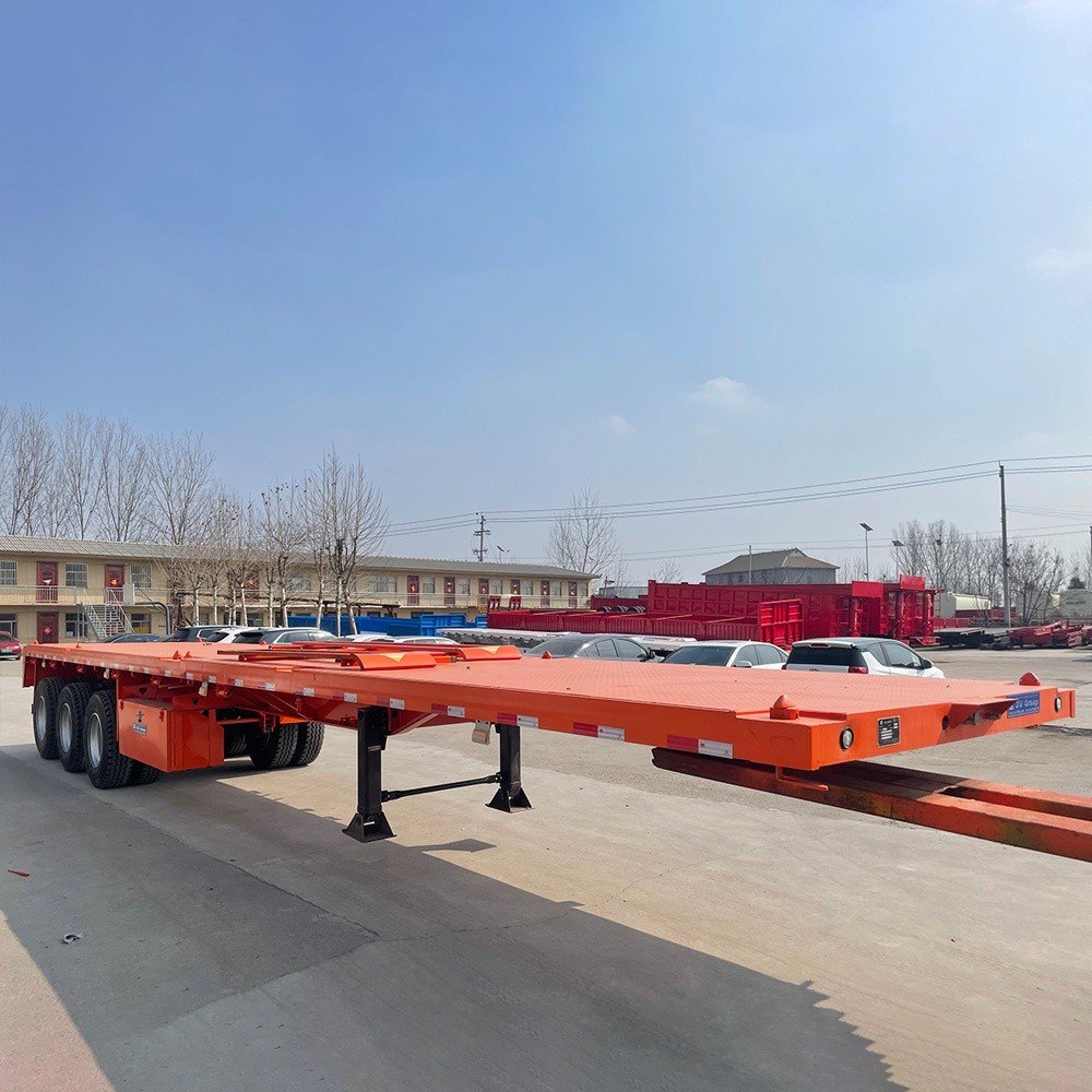3 axle 40ft flatbed container semi trailer front three quarter view highlighting container locks and axle layout