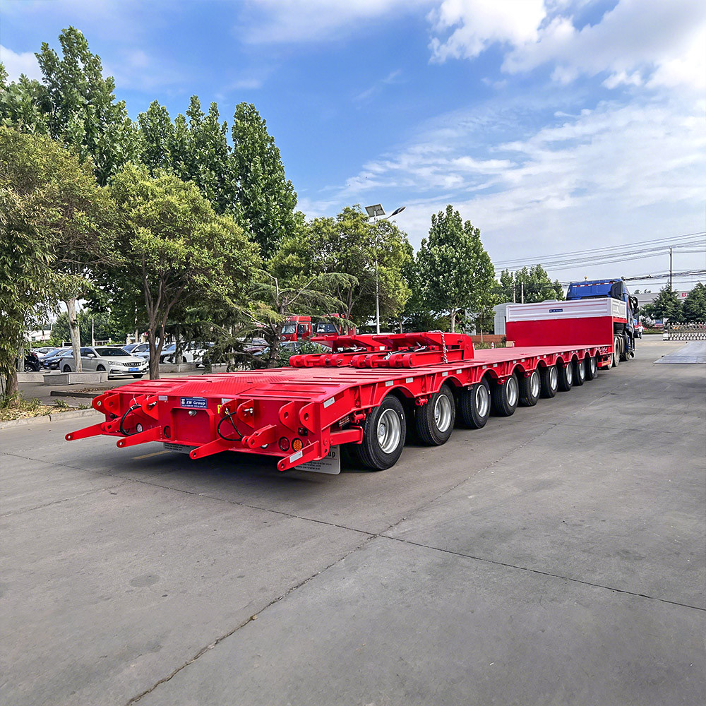 9 axle lowbed semi trailer rear three quarter view showing heavy-duty loading ramps and rear frame