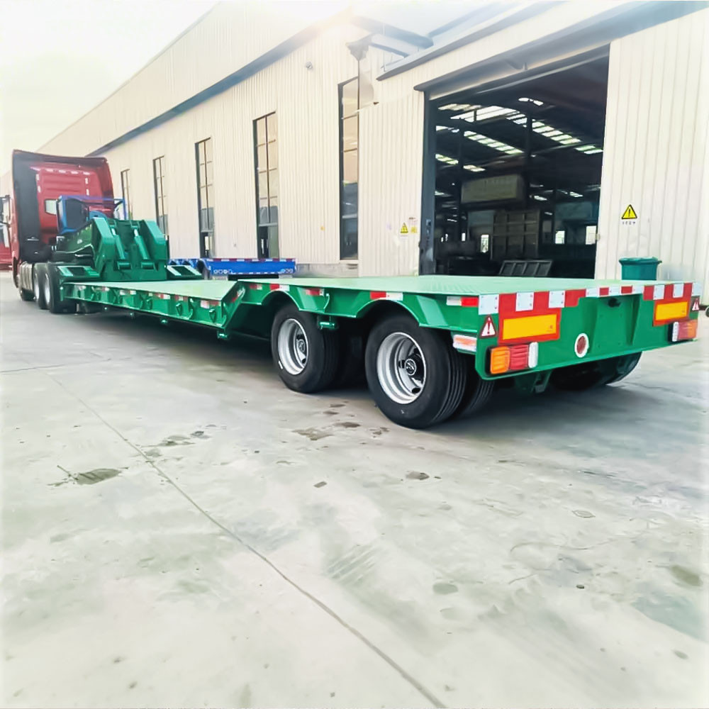 2 axle 60 ton removable gooseneck lowboy trailer rear three quarter view showing heavy-duty loading ramps and rear frame