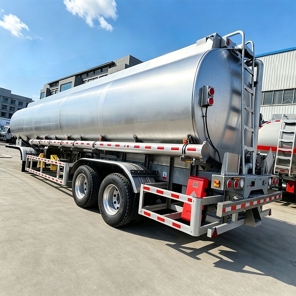 Rear view of 2 axle aluminum fuel tanker semi trailer with ladder and bumper