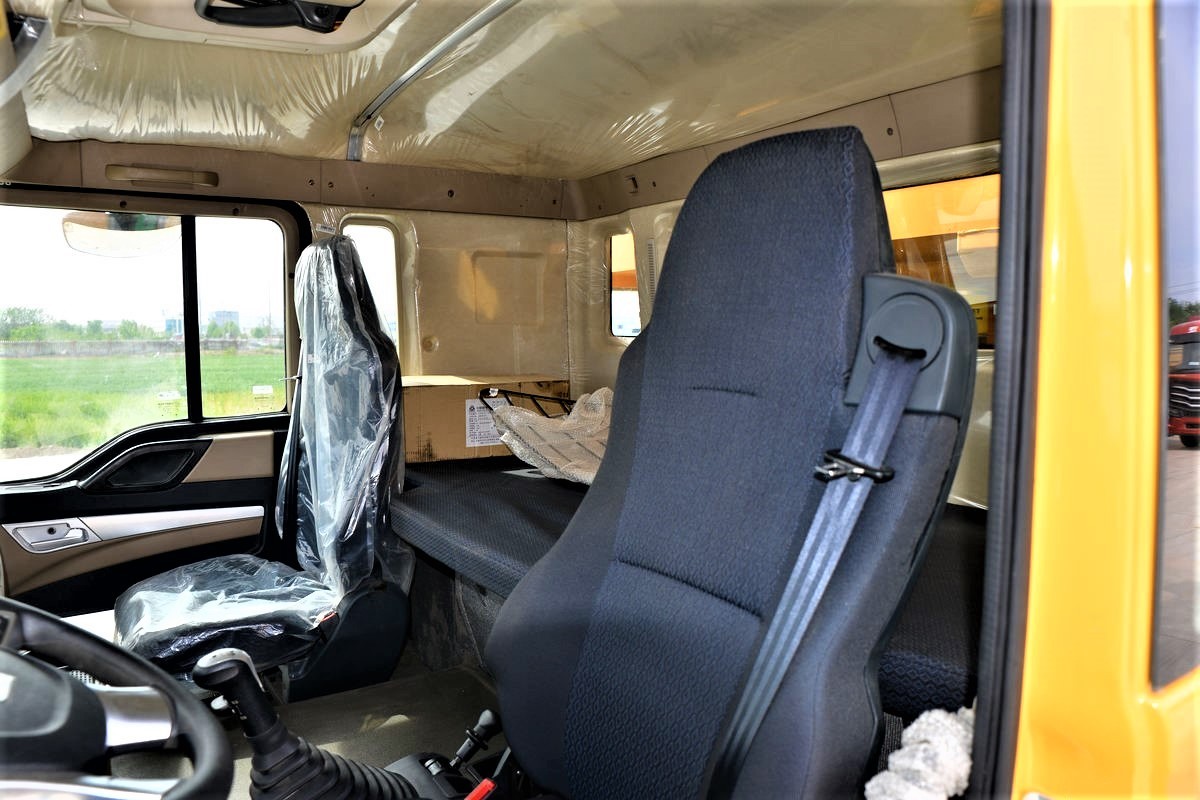 HOWO TX 440HP 8x4 dump truck cabin interior close-up showing ergonomic driver seat and dashboard شاحنة قلابة HOWO TX بقوة 440 حصان 8×4