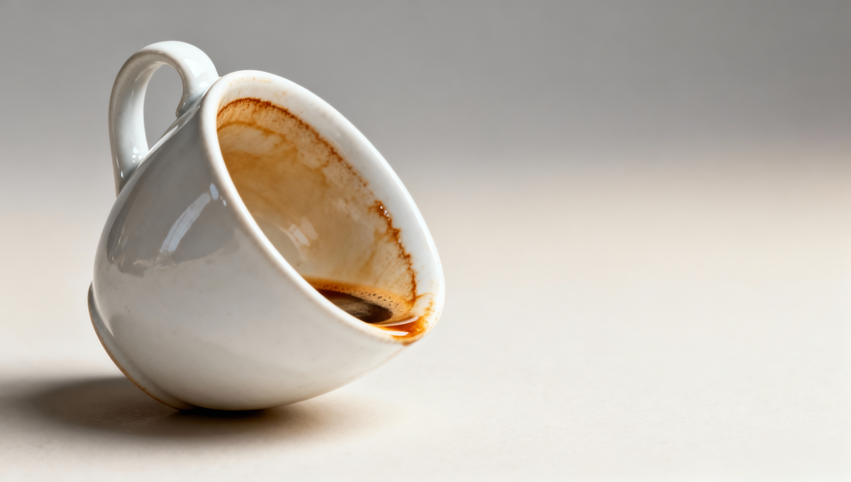 Stoneware mug interiors staining from coffee oils—glaze porosity or long-term polymerization effect?