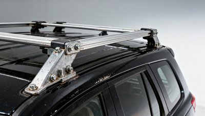Roof racks bolted to factory-installed rails — yet cause paint chipping and rail deformation over time. Is the mounting method flawed?