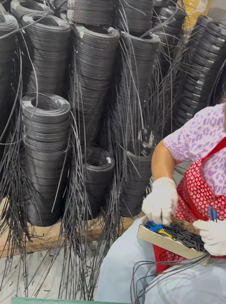 Technician fitting protective sleeves and connector components to pre-cut drop cables Technician fitting protective sleeves and connector components to pre-cut drop cables