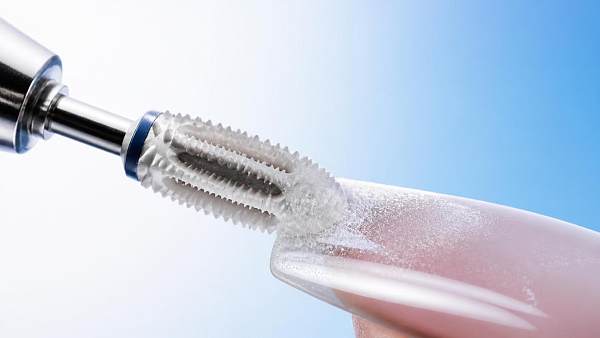 Why does a ceramic nail drill bit stay cooler during filing?