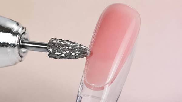 What causes a carbide nail drill bit to leave rough gel edges