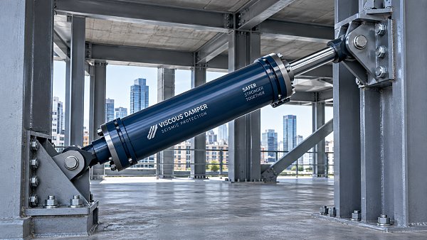 How does a shock absorber in a building dissipate earthquake energy?